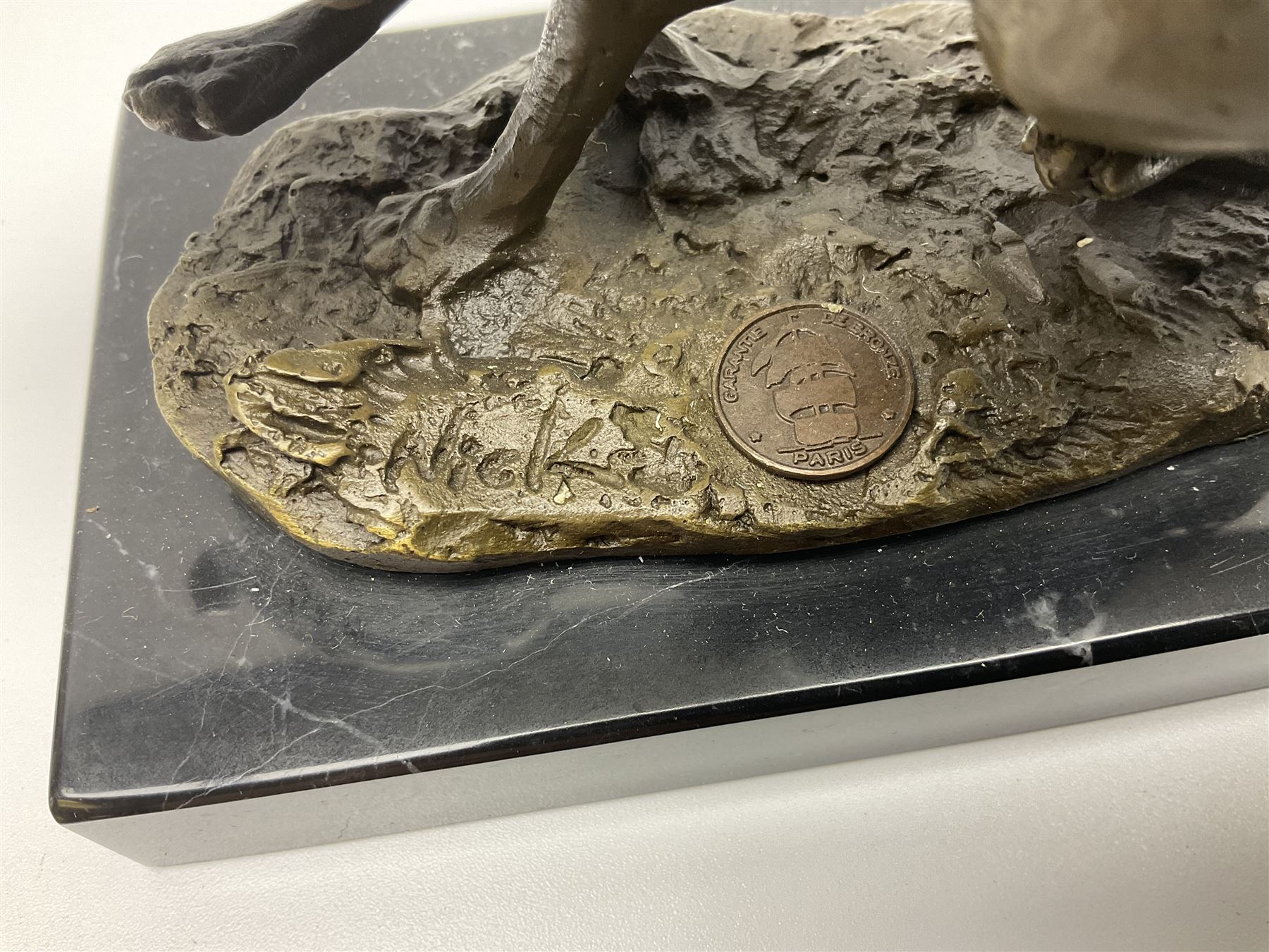 Bronze figure group, modelled as two hares in chase, upon a naturalistic base signed Nick and with foundry mark, raised upon a rectangular marble base, overall H12cm. 