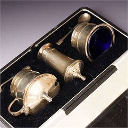 Silver three piece condiment set of circular design and two original spoons, cased Birmingham 1937-1939 Maker Deakin & Francis Ltd 