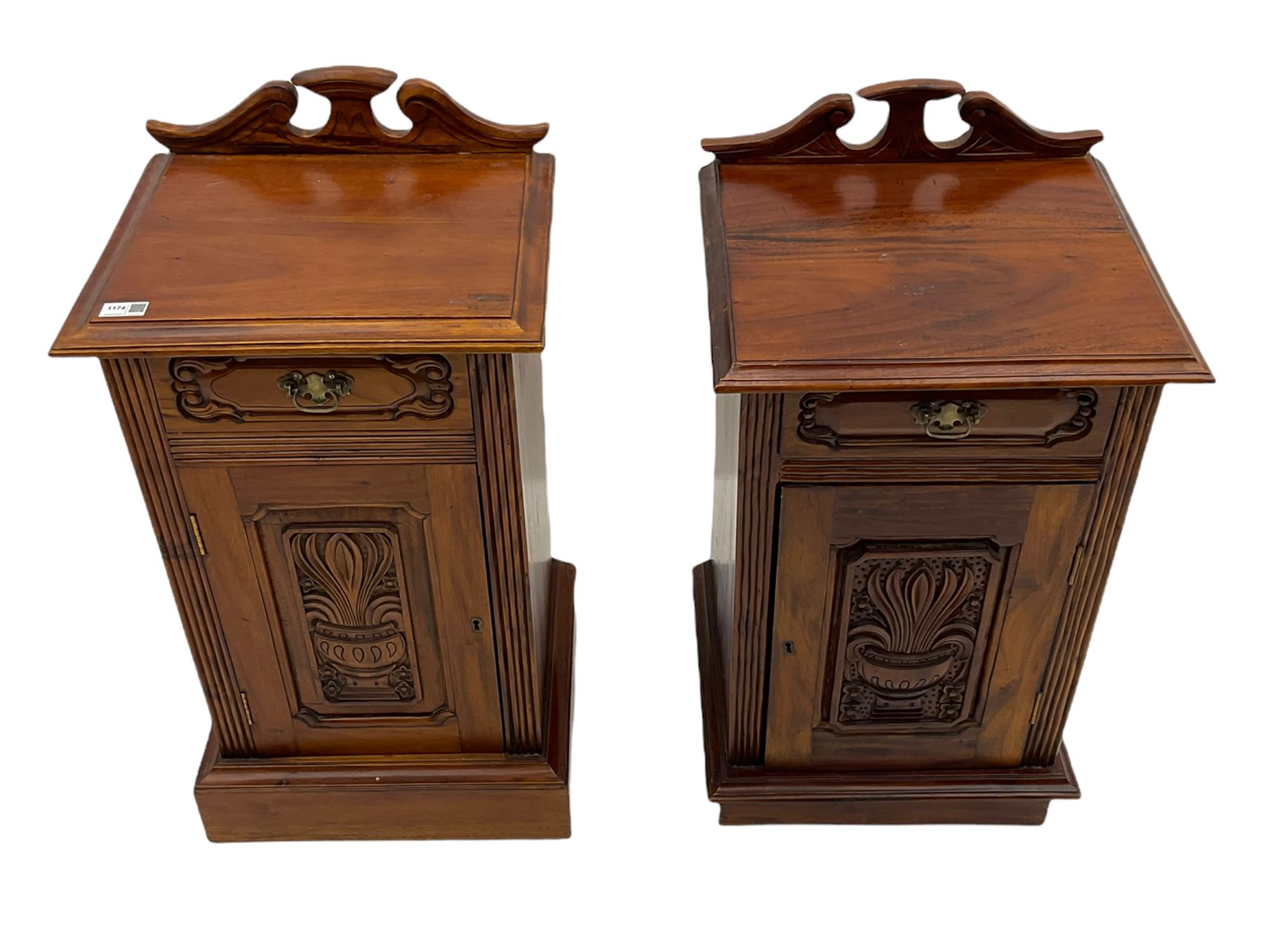 Pair Victorian style hardwood bedside cabinets, fitted with single drawer and cupboard, the doors carved with floral urns, on plinth bases