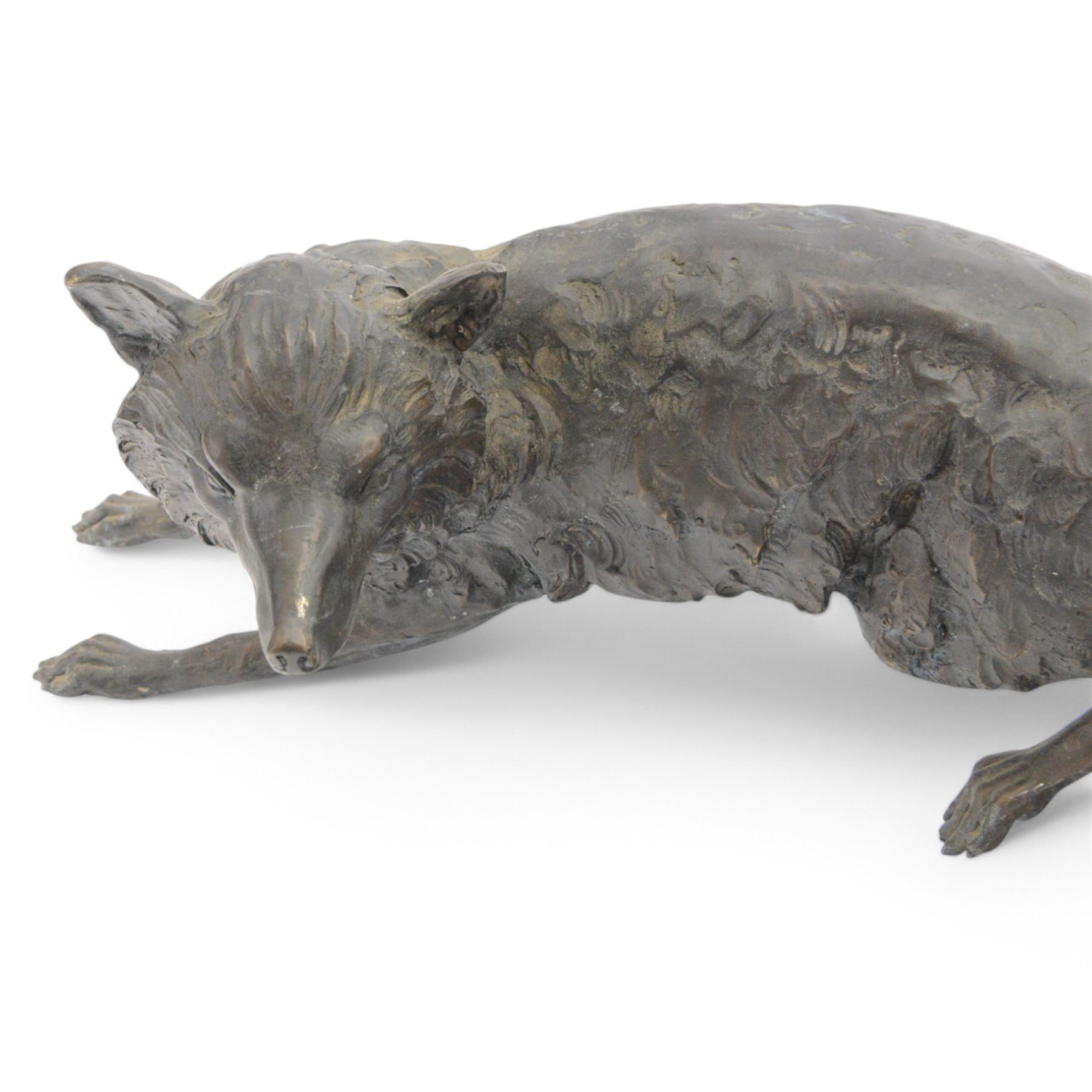 Spelter figure of a crouching fox, H24cm, L70cm 