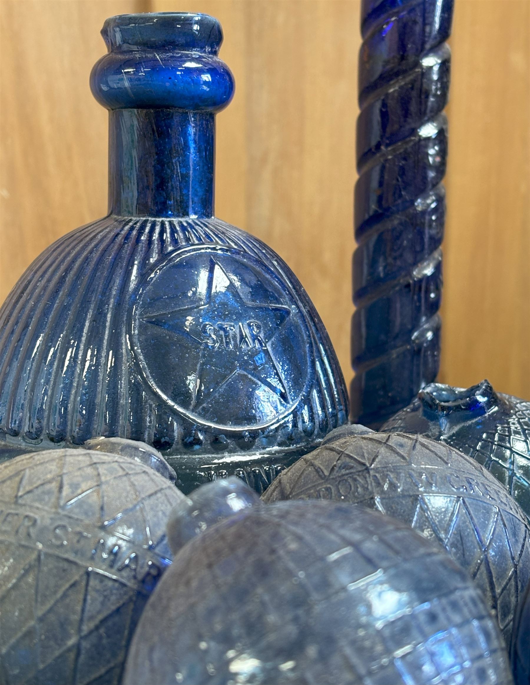 Collection of Victorian Bristol blue glass fire grenades, including an intact 'Star Hardens hand grenade fire extinguisher,' six smaller examples, some reading WW Greener, and a Minimax patent. (8) - COLLECTION BY APPOINTMENT FROM: The White House, Thirsk Road, Easingwold, York, YO61 3NF - CALL 01723 507111 TO ARRANGE