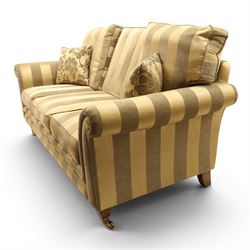 Alstons - 'Ixworth' three seat sofa, upholstered in striped fabric, with loose seat cushions and scrolled arms, front brass castors