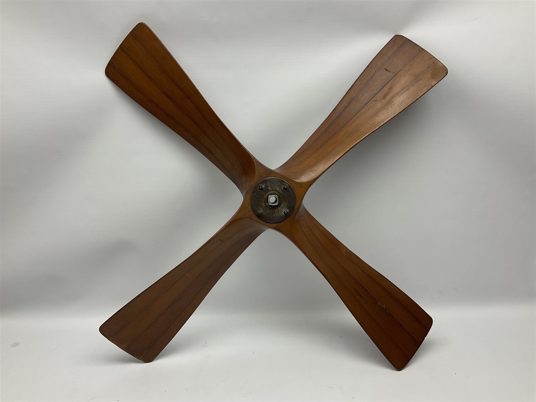 British World War II era laminated wooden four-bladed generator propeller, late 1930s-40s, used to power a drogue winch used by a target tug aircraft; marked with DRG drawing number T29505-2-4 N760 on the hub and impressed circle mark 'P.M.P.W. 1'; light weight four plank mahogany laminate with 9.5cm diameter metal plates mounted to front and rear faces of hub for 15mm shaft; one plate marked T29504-2/198 D91cm; together with a modern reproduction brass edged mahogany two-blade propellor L