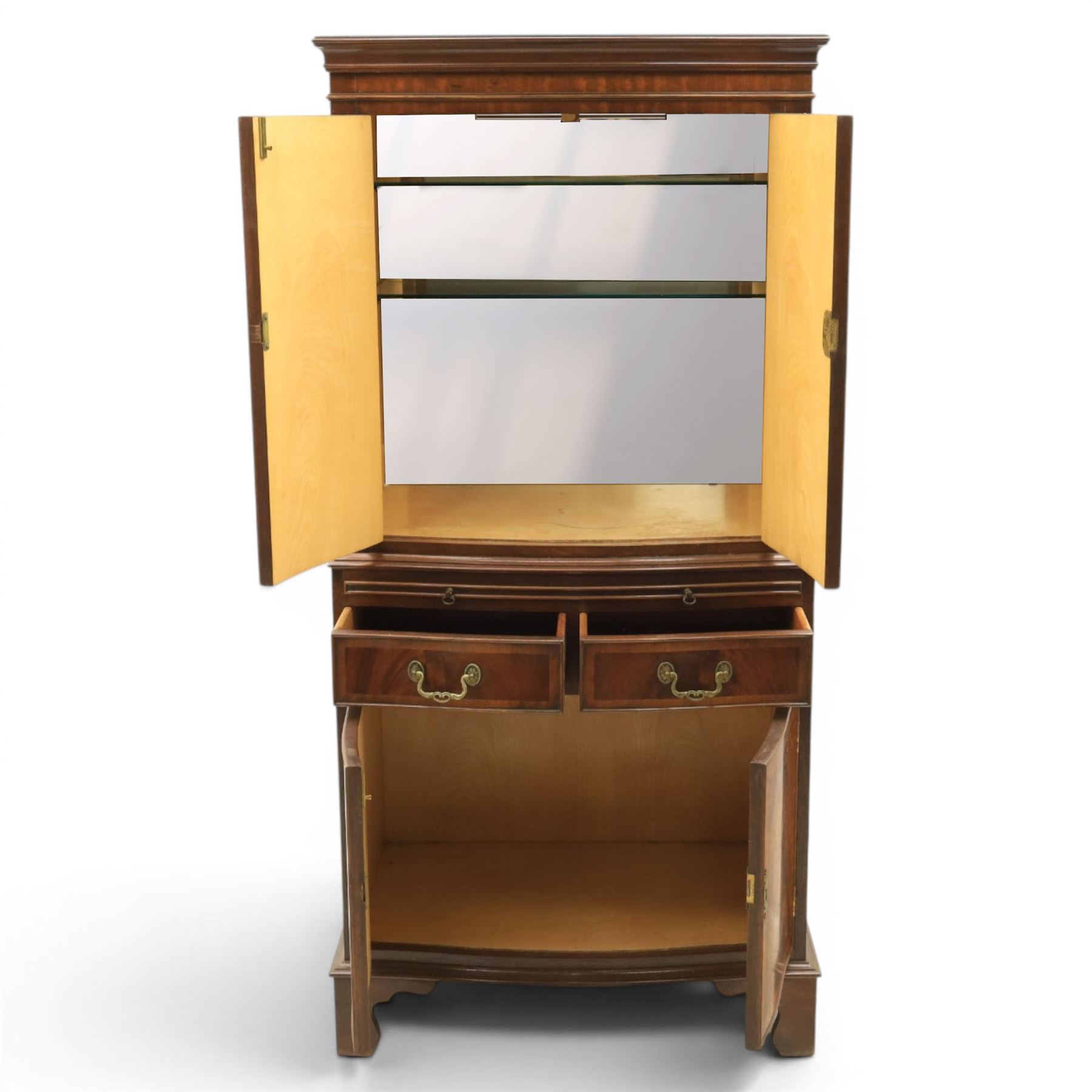 Georgian design mahogany cocktail drinks cabinet, bow fronted with mirrored and maple interior, slide out mirrored serving area, over two drawers and a cabinet below, raised on bracket feet