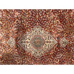 Persian amber ground rug, the central shaped pole medallion surrounded by scrolling foliate decoration with extending branches, the multi-band ivory border decorated wit repeating palmettes