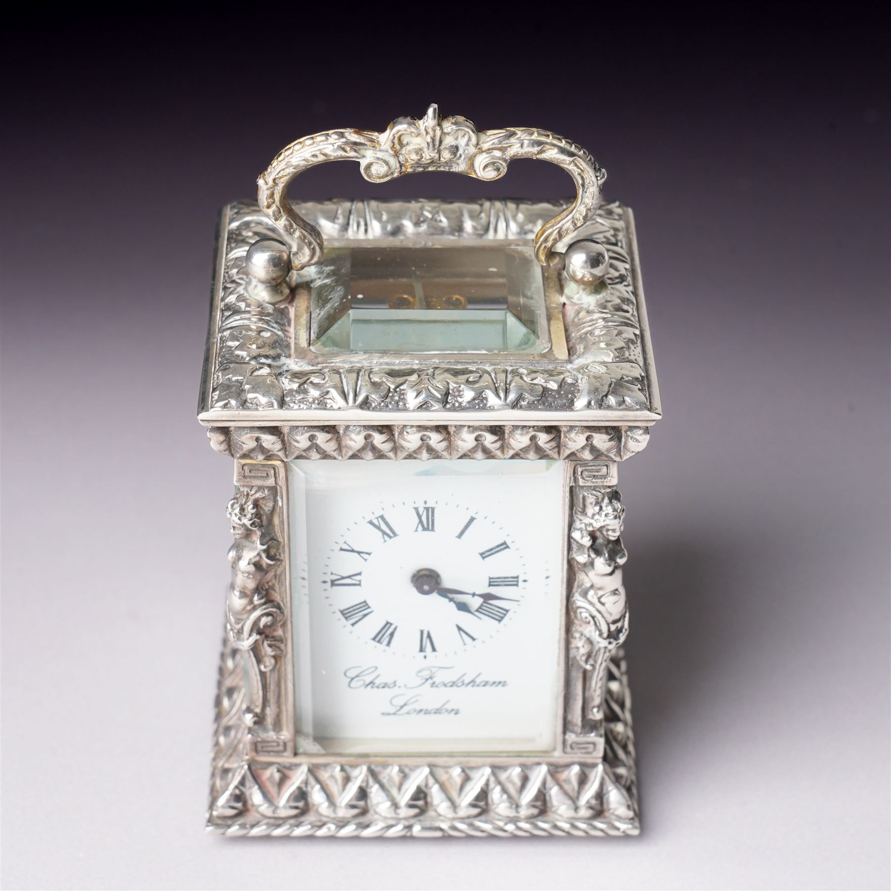 Chas Frodsham -  Miniature carriage clock with white dial and platform lever escapement in cast silver case with caryatid columns and bevelled glass panels H10cm  London assay No.0468
