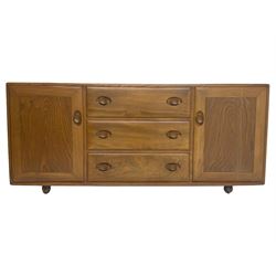 Ercol - mid-20th century blonde elm 'Windsor' sideboard, fitted with three drawers flanked two cupboards, on castors