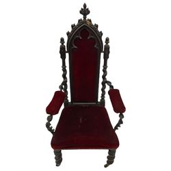 Victorian oak and wrought metal Gothic open armchair, the pointed arched back carved with foliate, cusped inner arch upholstered in red, spiral turned uprights and supports, with arms made of spiral forged metal