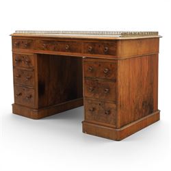 Victorian figured walnut twin pedestal desk, brass galleried top with inset tooled green leather writing surface, above three frieze drawers, raised on two pedestals with three drawers, on plinth bases above castors
