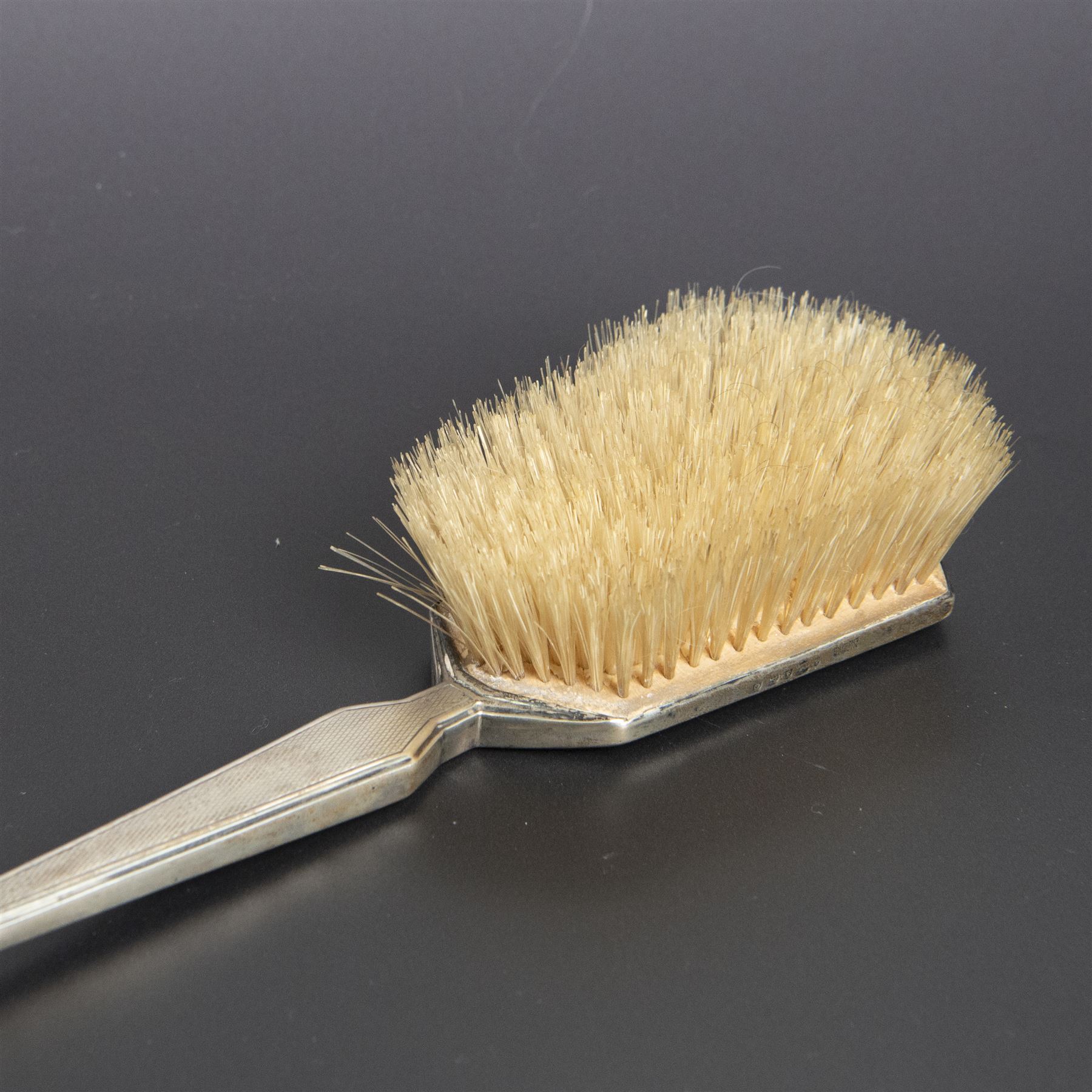 1930s silver mounted three piece dressing table set, comprising hand mirror, hair brush and clothes brush, hallmarked Barker Brothers Silver Ltd, Birmingham 1931