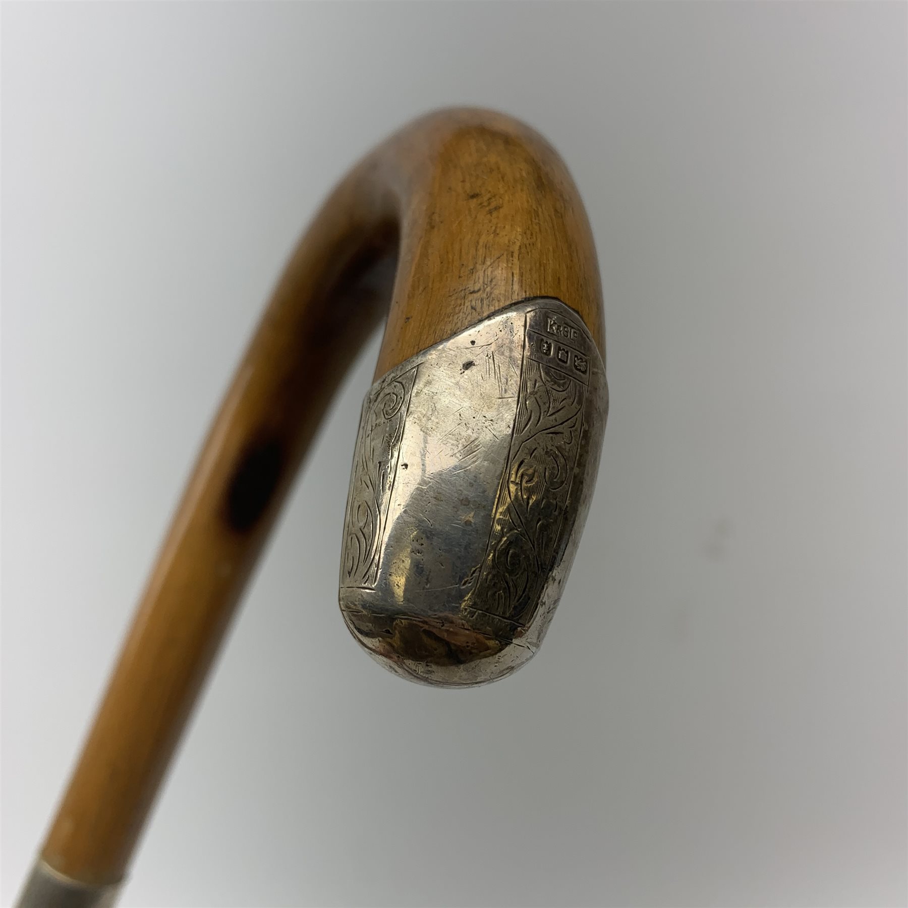 Three silver mounted walking canes, the first hallmarked Kendall & Sons Ltd, London, date letter worn and indistinct, the second hallmarked Birmingham 1924, maker's mark C&S, the third marked Sterling Silver, C&S. 