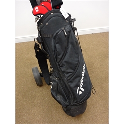  Set of 'TaylorMade' golf irons, putters, woods with matching bag and a trolley  