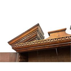 18th century walnut bookcase on bureau, the bookcase with sloped top pediment over two panelled doors and candle slides, fitted with two adjustable shelves and pigeon holes, the bureau with fall front enclosing a well fitted interior, with a combination of pigeon holes, drawers and secret compartments, fitted with two small and four long graduating drawers, on bracket feet