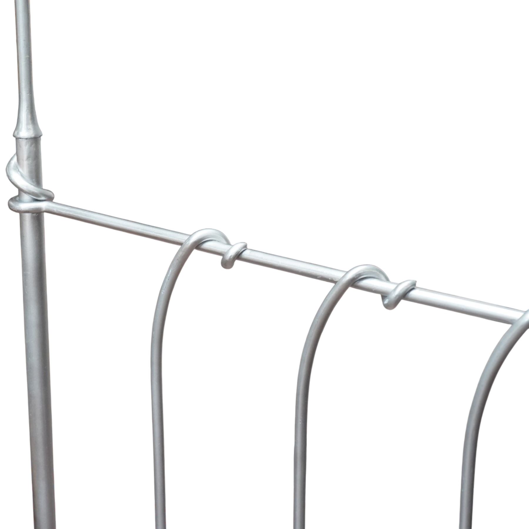 And So To Bed - 'Squigalina' silvered metal framed 5ft king size four poster bed, the tubular chrome posters in scrolling foliate form, over a shaped and scroll-topped metal spindle headboard and footboard