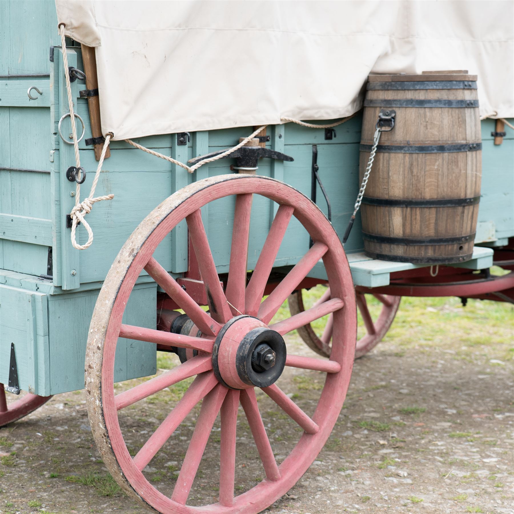 Western Covered Chuck Wagon

A large four wheeled covered wagon of timber construction, painted pale green with red painted wooden spoked wheels and a cream canvas tilt over an arched frame. The wagon has a traditional box body with covered rear compartment, front driving position, underbody turntable steering and iron fittings throughout. Fitted with external equipment details including a side mounted barrel, lidded storage chest, rope tie downs, horseshoe fittings and rear storage box.

Features

• Pale green painted timber body
• Cream canvas tilt over arched frame
• Covered rear compartment
• Front driving position
• Side mounted barrel
• External lidded storage chest
• Rear storage box
• Wooden spoked wheels
• Iron tyres
• Underbody turntable steering
• Rope tie downs
• Horseshoe fittings
• Iron hardware and brackets
• Brass restoration plaque to rear

Dimensions:
Overall length: 335 cm
Width: 170 cm
Height: 275 cm

Wheel Diameters:
Front wheels: 92 cm
Rear wheels: 112 cm

Seating:
Driver: 1
Passenger: Rear covered compartment