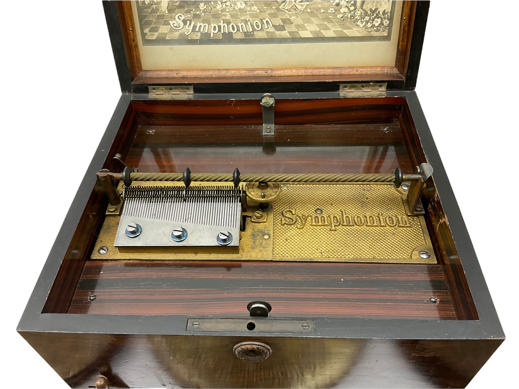 Late 19th century Symphonion disc musical box in inlaid walnut case with front lever action playing 25.5cm discs on a 10.5cm steel comb with forty-nine teeth, musical scene of cherubs under the lid, L33cm; together with five 25.5cm discs, fifteen 20.5cm discs and eleven 19cm discs