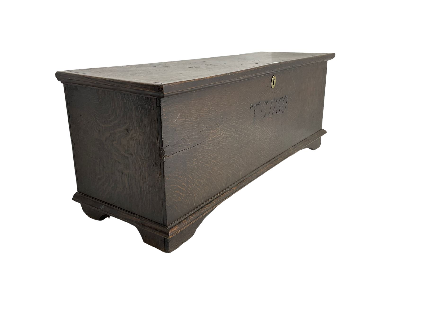 18th century oak sword chest or coffer, hinged lid with moulded edge and iron fittings concealing candle box and main compartment, the front with studwork spelling 'TC 1750', raised on bracket feet