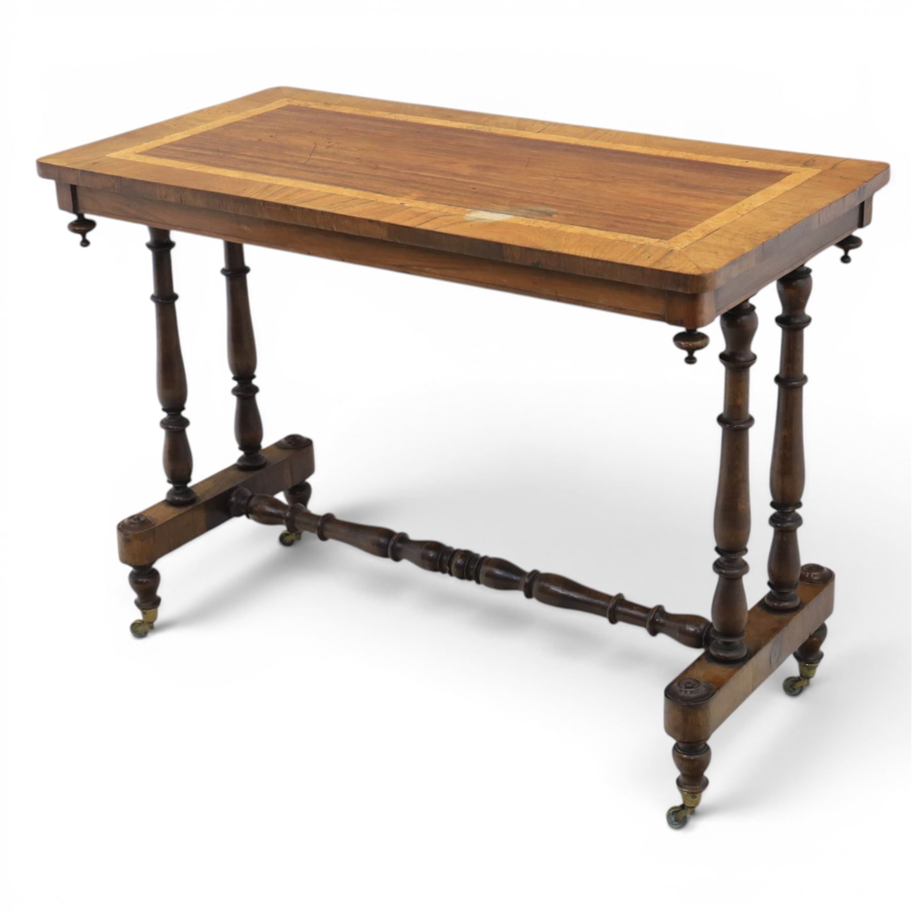 Victorian rosewood and beech stretcher table, rectangular walnut banded top, four turned legs and stretcher, raised on brass castors