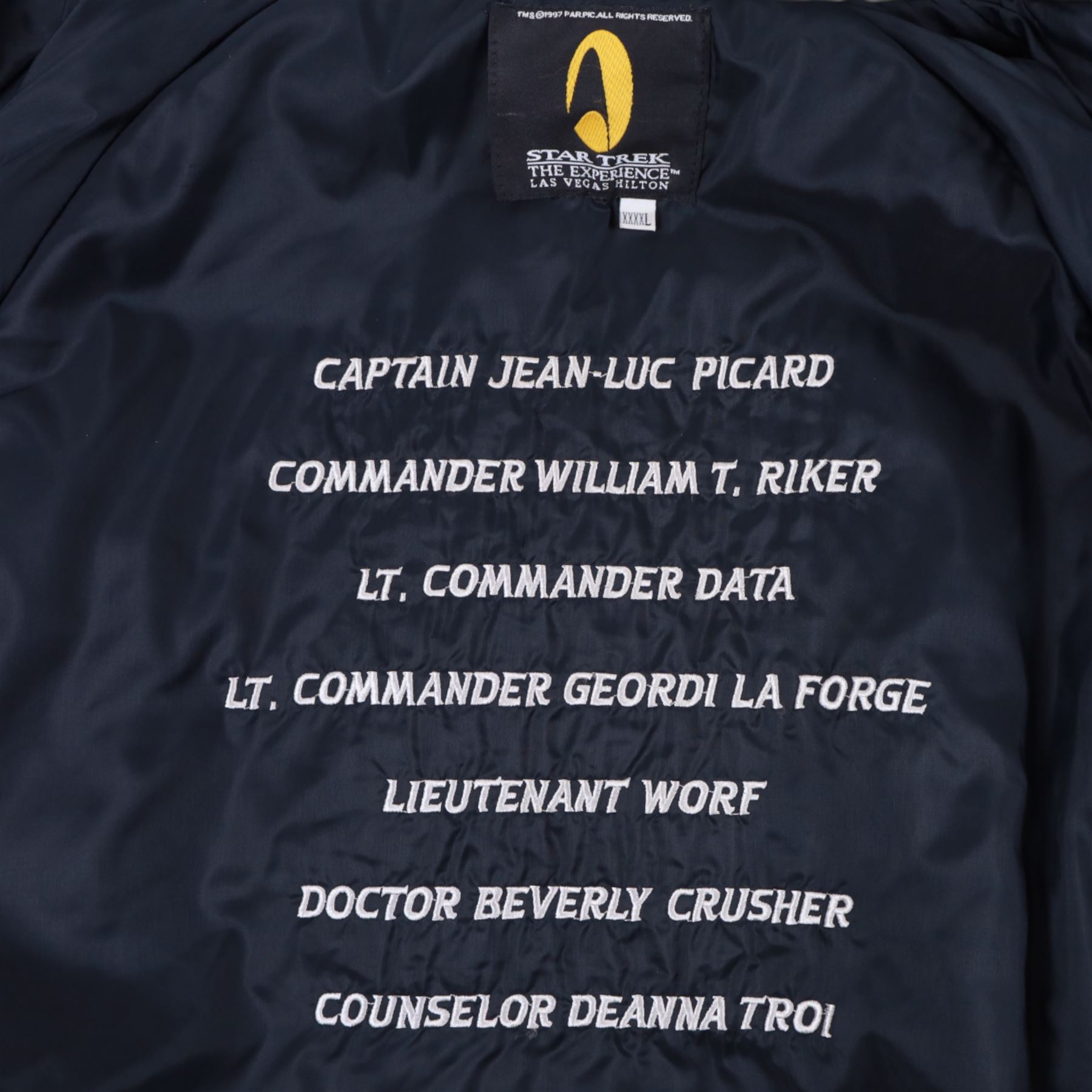 Star Trek The Next Generation 10th anniversary jacket, leather sleeves and collar with embroidered decoration throughout, including 10th anniversary emblem to back, 'Star Trek The Next Generation' to collar, 'Paramount Pictures Stages 8,9 & 16' to front and seven character names to interior, in size XXXXL, purchased in 1990s from Star Trek Experience Las Vegas