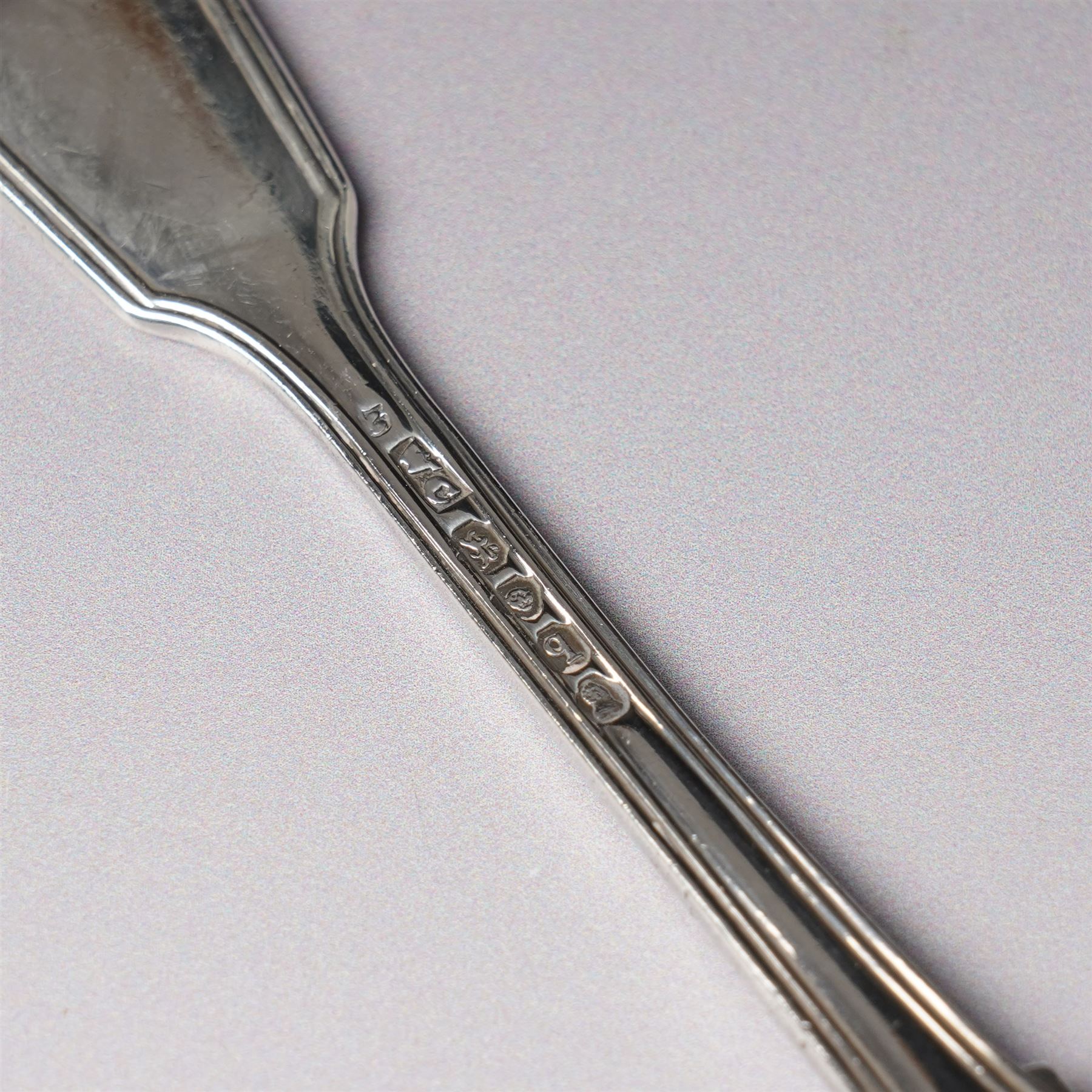 Pair of engraved silver napkin rings London 1912, two 19th century fiddle pattern dessert spoons, four condiment and teaspoons and a silver pepperette