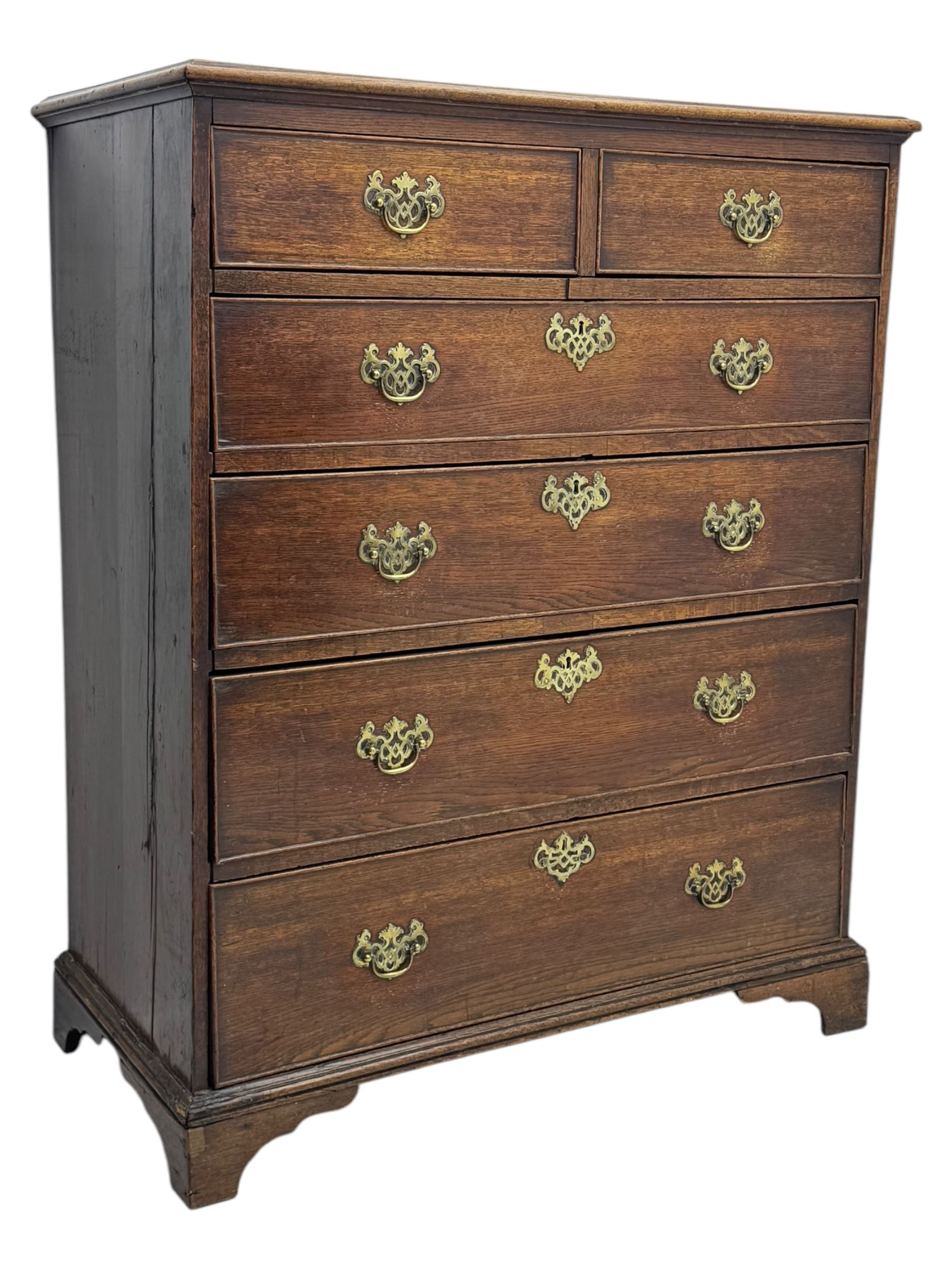George III oak chest of drawers fitted with two short over four long drawers fitted with swan neck handles, supported on bracket feet