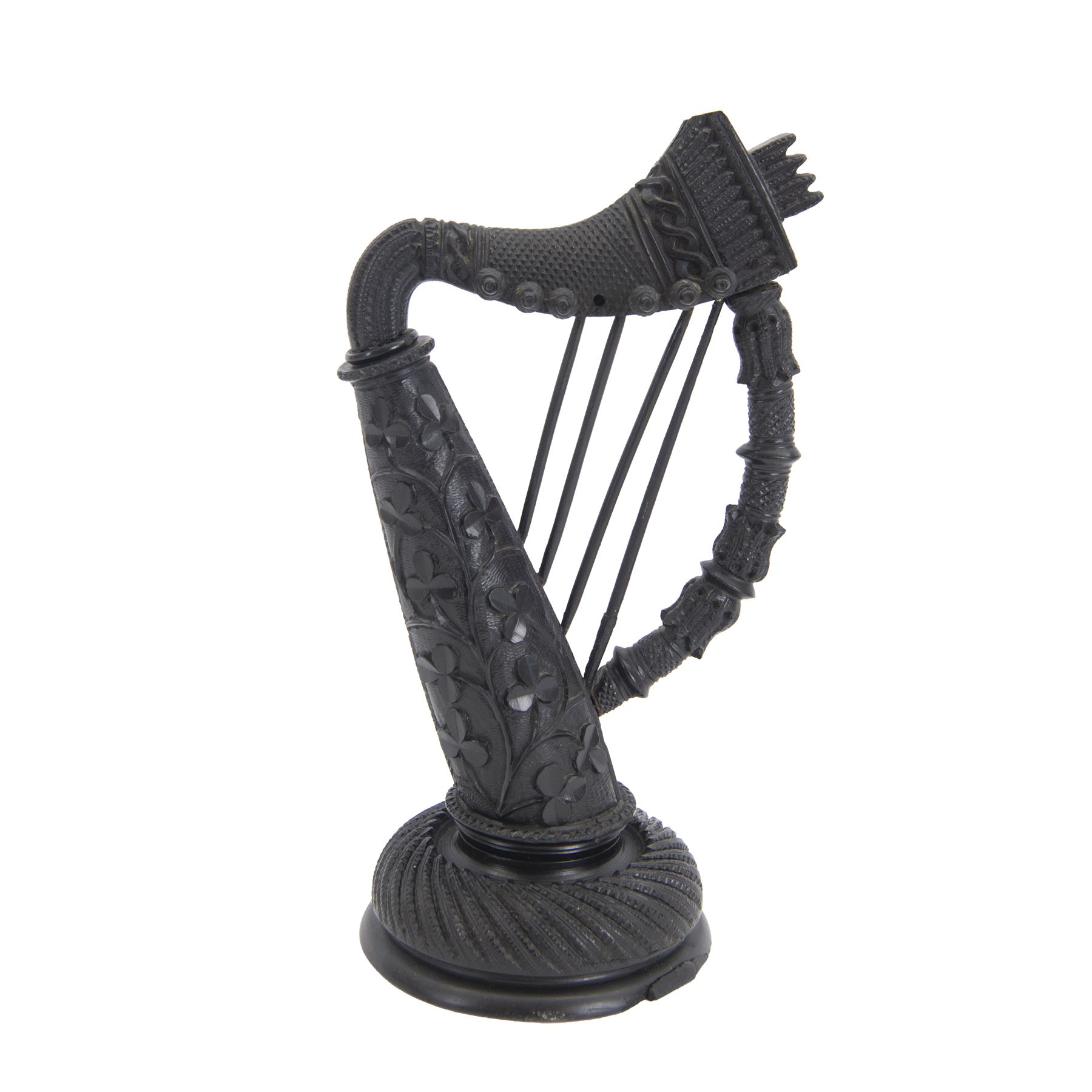 19th century Irish carved bog oak model of a harp, detailed with fluting, diamond cuts and shamrocks, upon a turned circular base, H29cm
