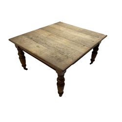 Late Victorian oak dining table, moulded rectangular top, four turned supports with brass and ceramic castors 