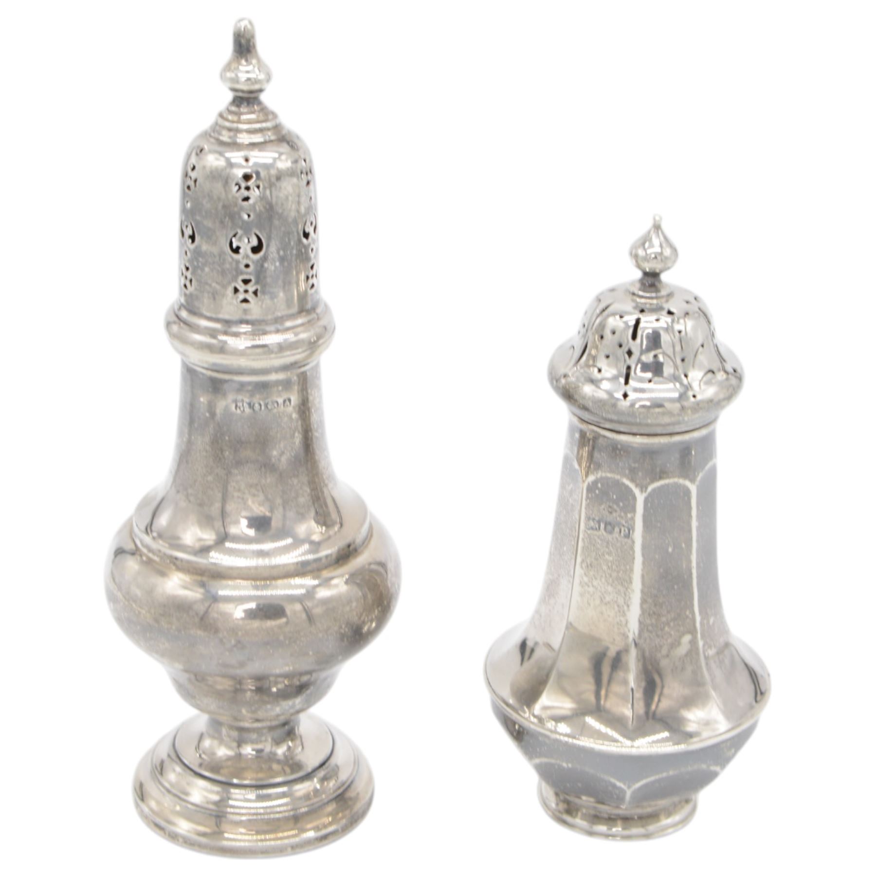 Two early 20th century silver sugar casters, the first an Edwardian example of faceted urn form, hallmarked Sibray, Hall & Co Ltd, London 1910, the second a 1920s example of typical urn form, upon a stepped circular filled base, hallmarked William Neale & Son Ltd, Birmingham 1925, tallest H20cm