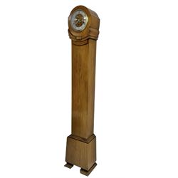English - 1930s light-oak cased 8-day grandmother clock, in a stylised case with a long trunk on raised feet, with a matching wooden dial centre and a silvered chapter with Roman numerals, three train Westminster chiming Garrard movement chiming the quarters and hours on 8 gong rods. With a lever platform escapement.