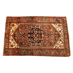North West Persian Zanjan hand-knotted rug, madder-red field with a central stepped lozeng...