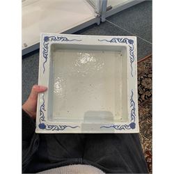 Chinese blue and white planter and stand, each of square slightly tapering and flared form, the planter decorated with two dragons and blossoming peonies, between stylised borders, the stand decorated with flower heads and vines, planter H30cm W29cm, stand H7cm D28.5cm