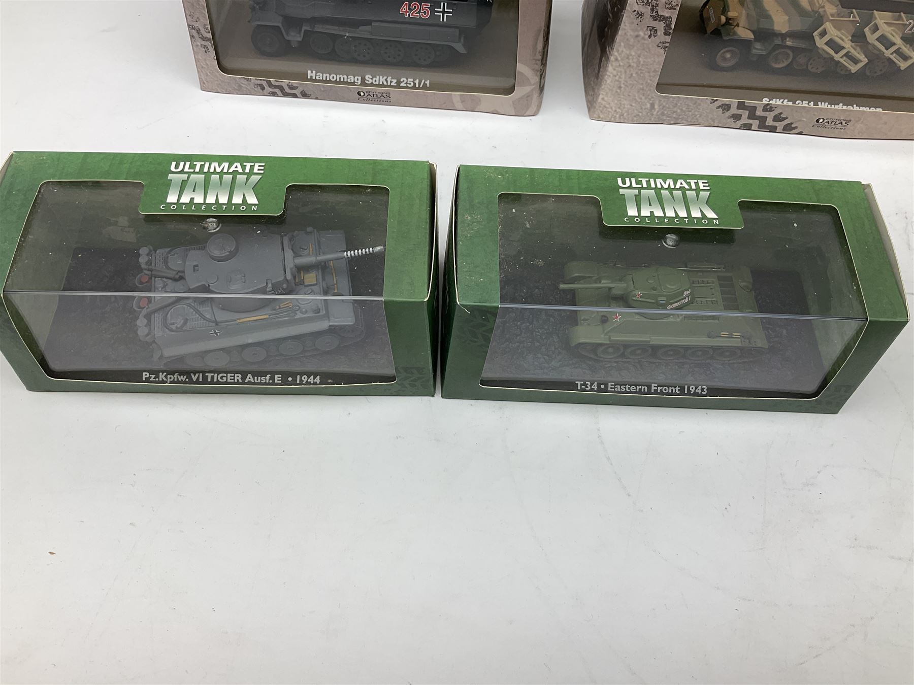 Sixteen Atlas Editions die-cast models of military vehicles including six Ultimate Tank Collection; all in perspex display cases; fourteen boxed; with associated paperwork (16)