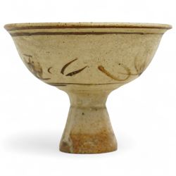 Chinese Song Dynasty (960–1279) Cizhou polychrome decorated wine stem cup, deep rounded sides over tall flared foot, decorated in iron-brown slip with stylized floral spray on a creamy-white slip ground beneath a clear glaze, base of foot unglazed, W11cm H8cm