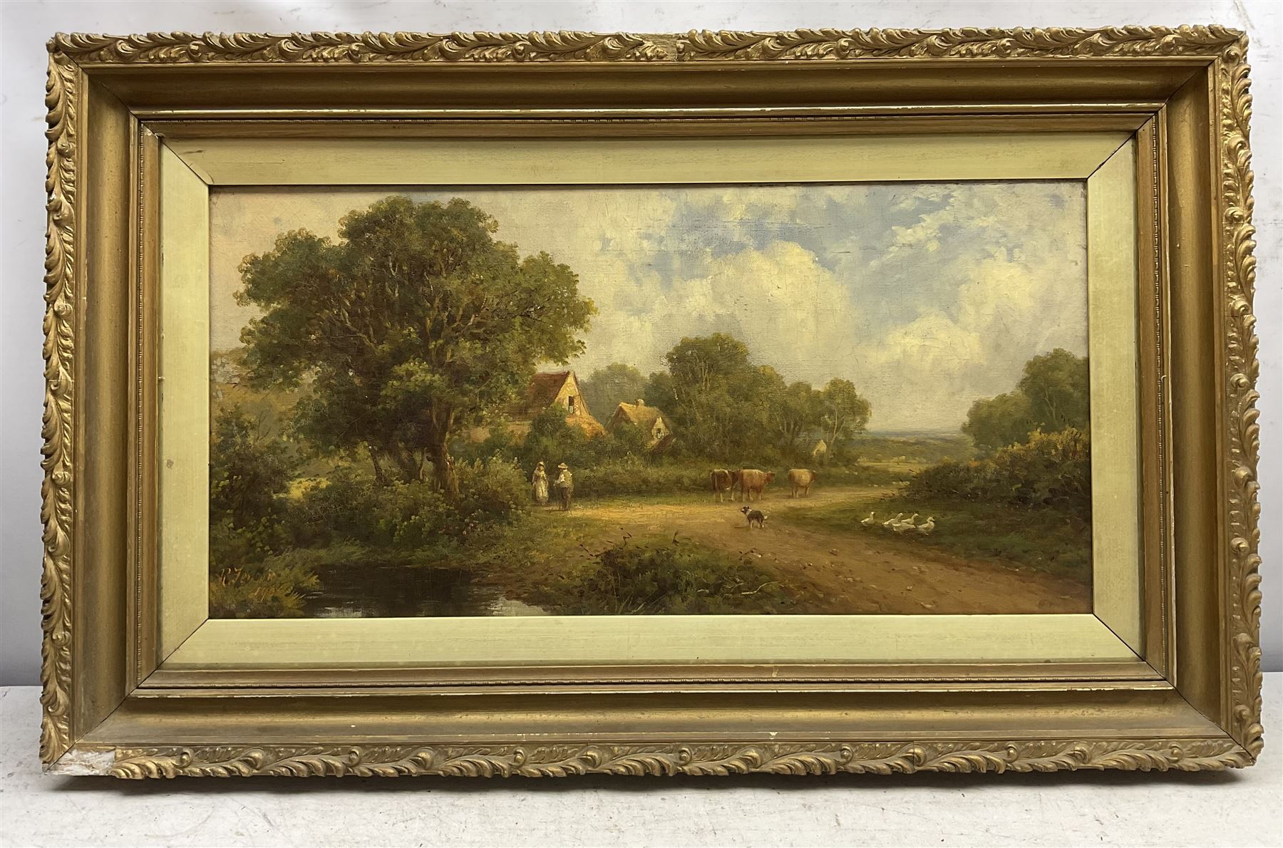 Robert Fenson (British 1889-1915): Couple Tending to the Farm Animals, oil on canvas signed and dated 1908, 29cm x 60cm 