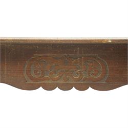 Arts and Crafts oak table, the rectangular top decorated with incised and carved scrolling foliage panels, the centre carved with a shield-shaped cartouche dated 1905, over a simple frieze with matching carved decoration to the front, on straight tapering legs