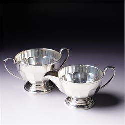 Silver three piece tea set of panelled circular form Birmingham 1929 Maker Synyer & Beddoes and a similar hot water jug Sheffield 1954 