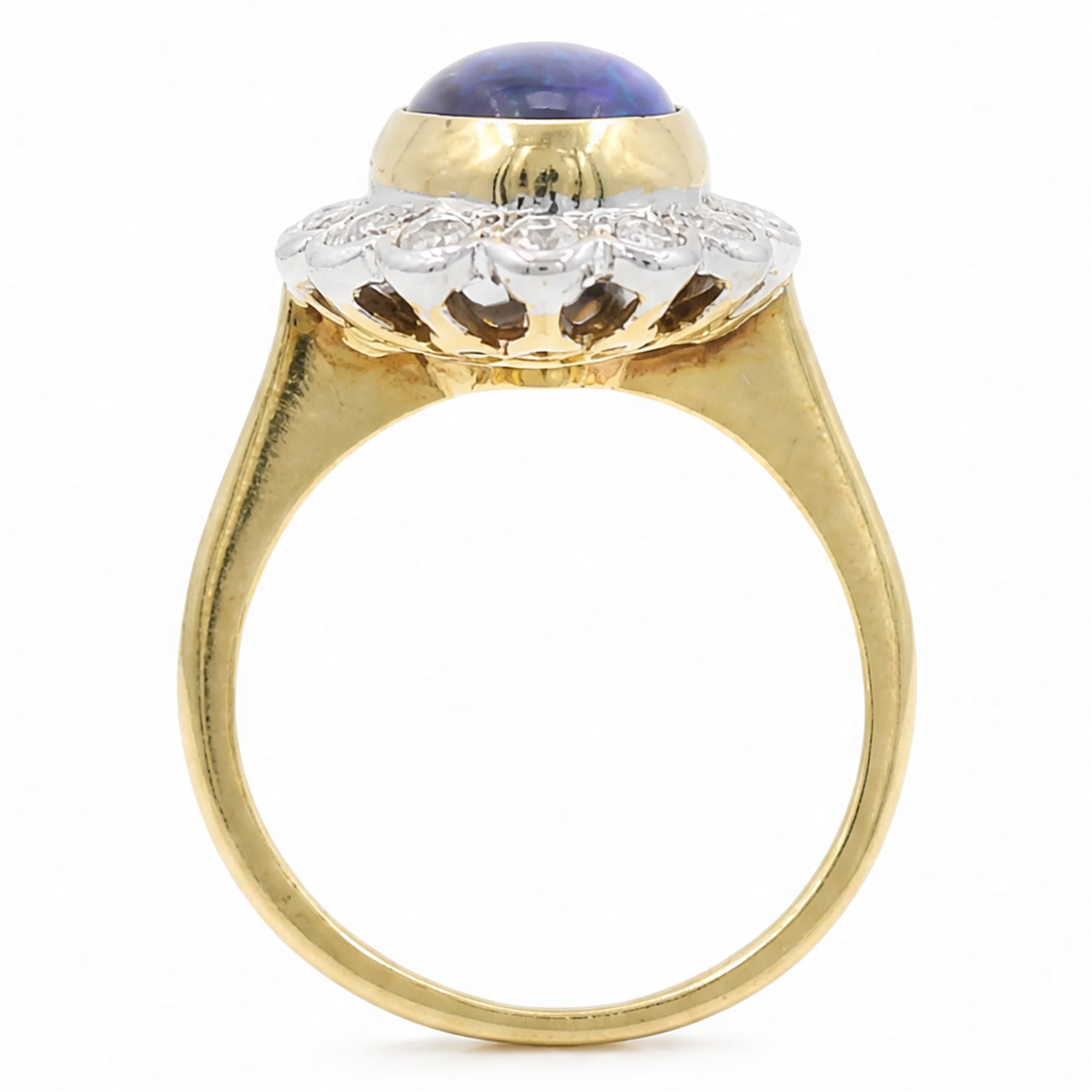 18ct gold black opal diamond cluster ring, single oval cabochon cut opal of 2.76 carat, surrounded by fourteen round brilliant cut diamonds, London 1998, total diamond weight 0.60 carat