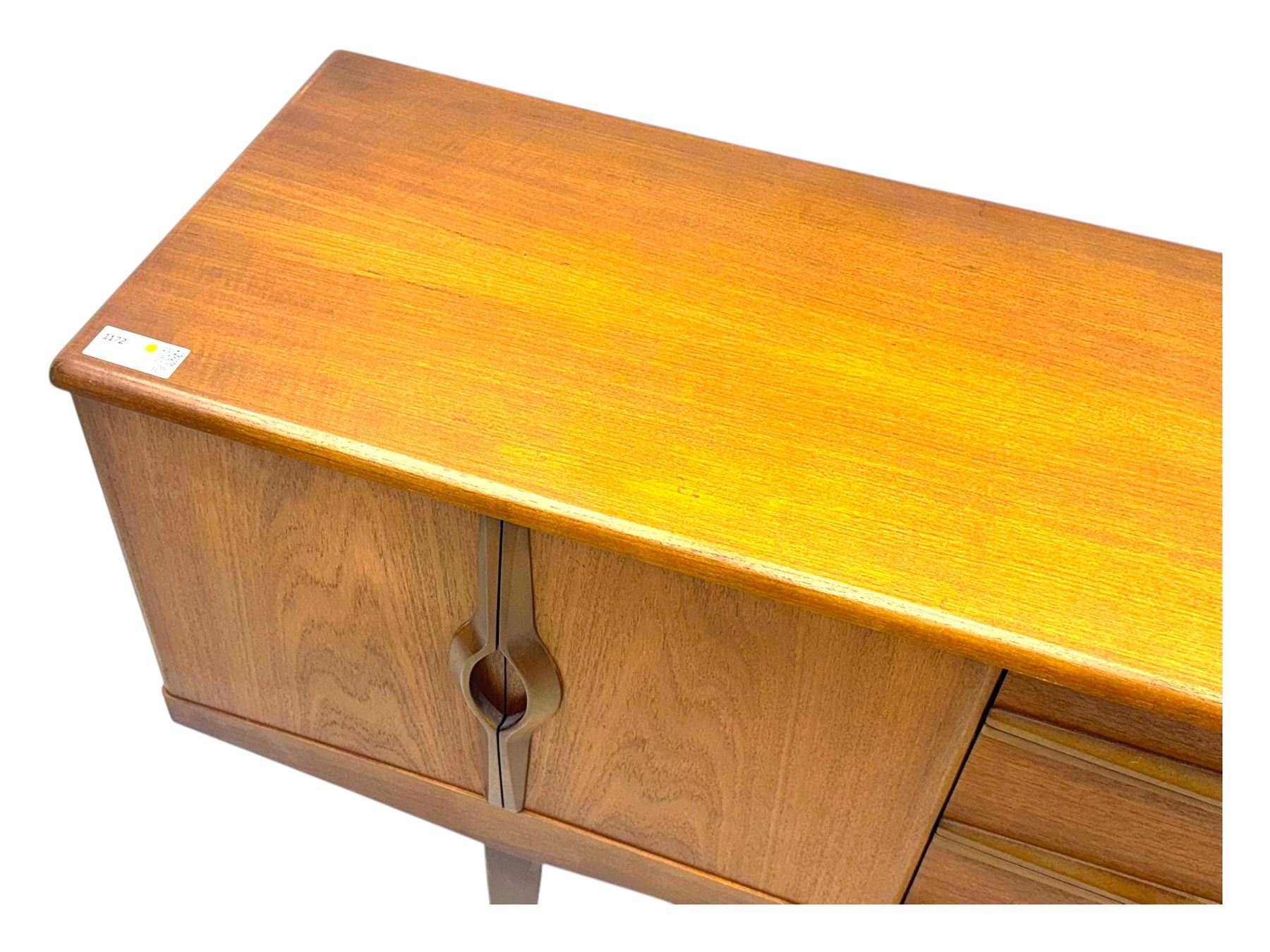 Stonehill - mid-20th century teak sideboard, three central drawers flanked by concertina cupboard doors, on tapering supports
