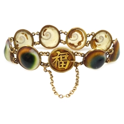  Chinese 18ct gold mounted operculum (evil eye) panel bracelet, stamped 18 with maker's mark WN and date mark, and four additional opercula  