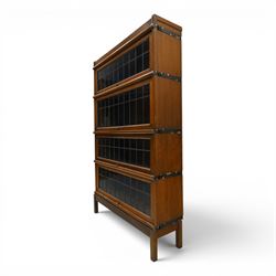Globe Wernicke - oak four tier barrister bookcase, with leaded glazed fronts, raised on square supports
