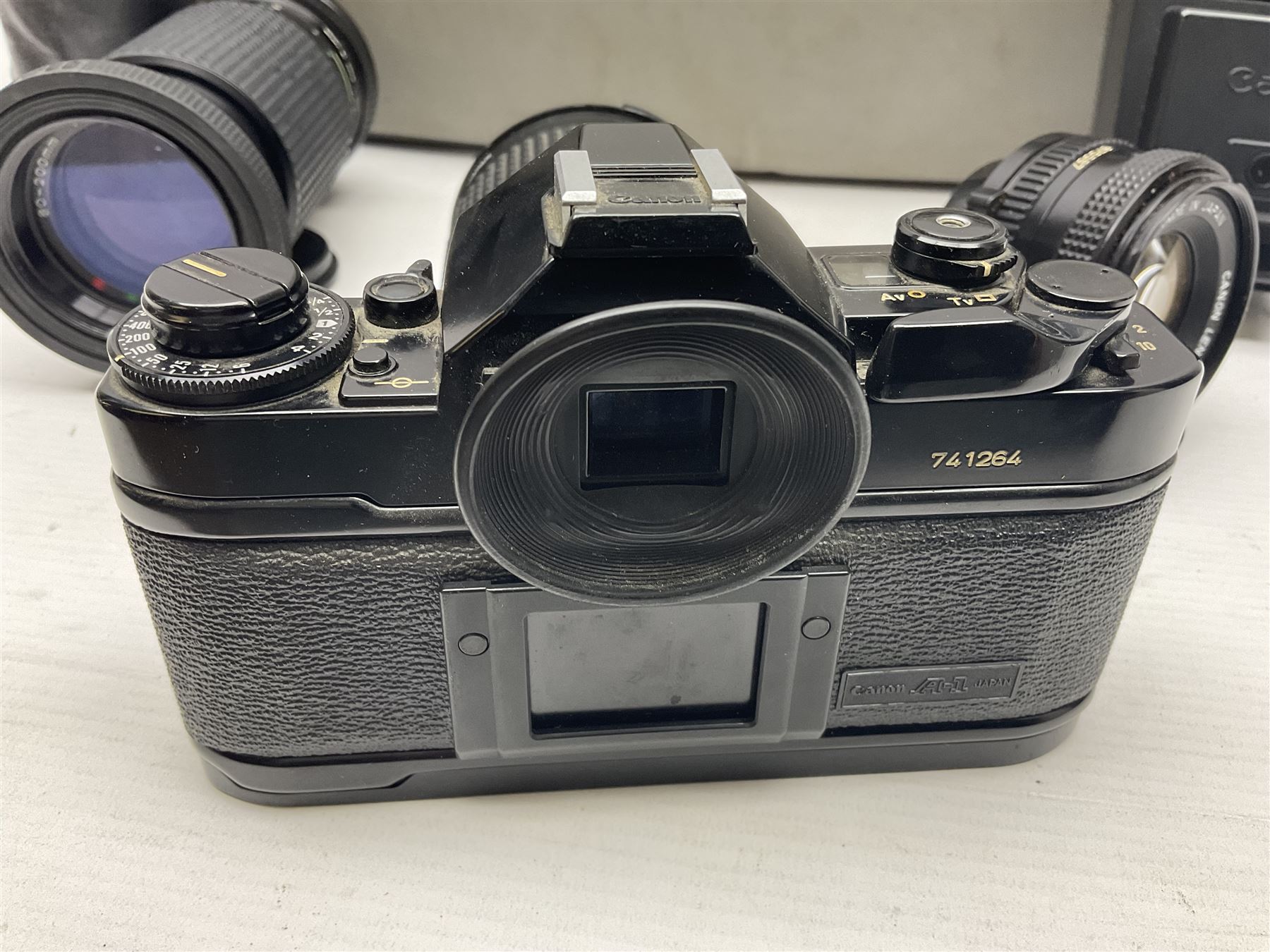 Canon A1 35mm camera body serial no 741264, with 'Tokina AT-X 28-85mm 1:3.5-4.5' lens serial no 821679, 'Canon FD 50mm 1:1.8mm' lens and other camera equipment 