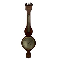 An early 19th century William IV mercury wheel barometer with a rosette inlaid broken pediment and correspondingly inlaid round base, mahogany veneered case with inlaid oval conch shell paterae and satinwood stringing to the edge, with an arched thermometer box and spirit thermometer measuring degrees Fahrenheit from 20 to 120, eight-inch silvered register reading barometric pressure in inches from 28  to 31, with predictions in Roman upper and lower case and script, dial inscribed “A Tagliabue,24 Grenville Street, Luther Lane, London”, with a steel indicating hand, brass recording hand and cast brass bezel.