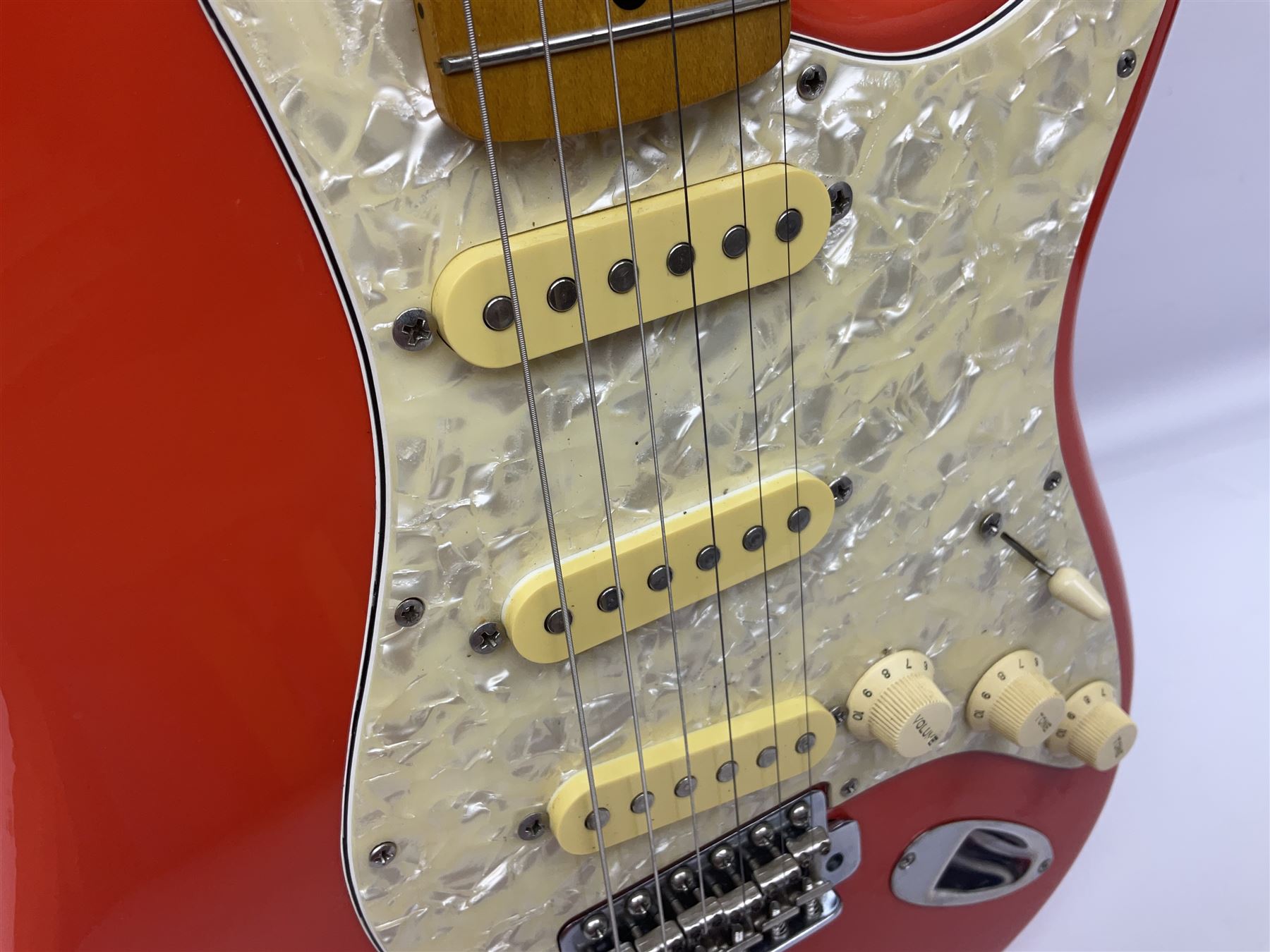 Japanese Squier Fender 'Hank Marvin' Stratocaster electric guitar, c1992, in Fiesta red with tremolo arm and facsimile signature decal; serial no.L037281, L98cm; in hard carrying case.