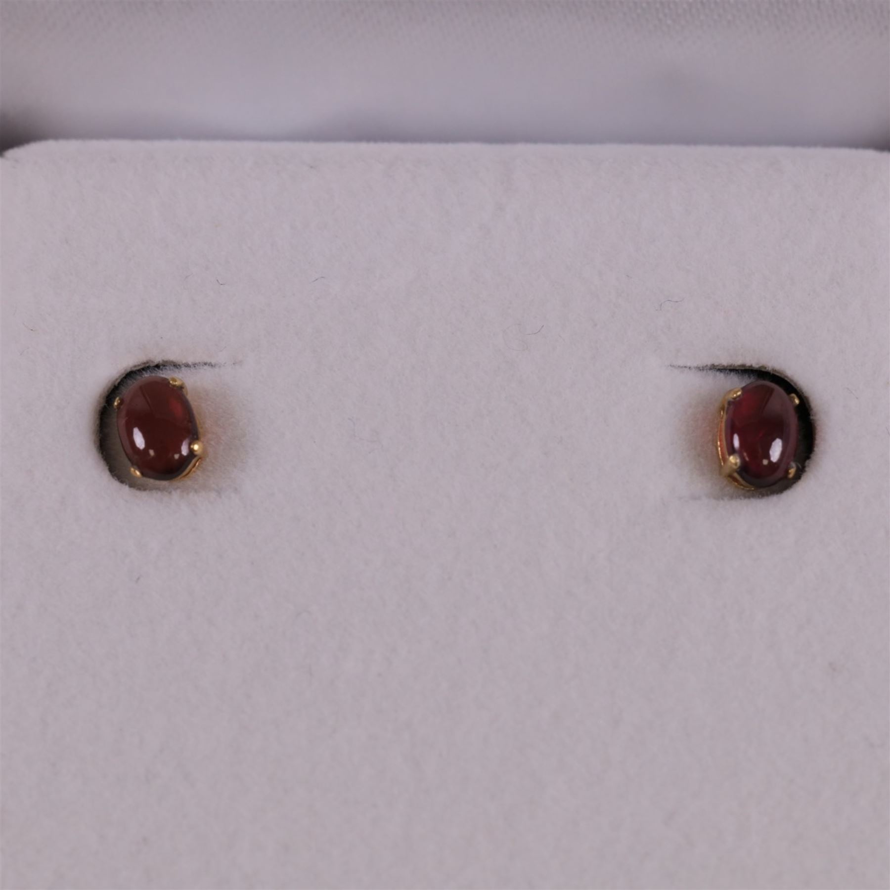 Pair of 9ct gold oval garnet stud earrings, boxed, H6mm