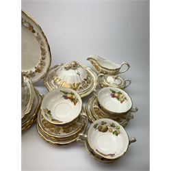 Extensive Spode dinner and tea service, decorated in the Golden Valley pattern, comprising eighteen dinner plates, ten salad plates, ten side plates, ten twin handled soup bowls and ten saucers, ten bowls, two sauce boats and two stands, two square serving dishes, smaller oval serving dish, two tureens and covers, two large oval serving platters, one smaller example, teapot, coffee pot, milk jug, twin handled lidded sucrier, and ten teacups and ten saucers, with red printed marks beneath 