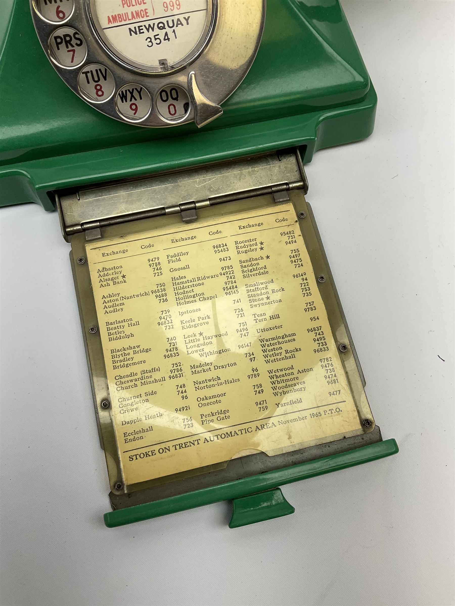 Jade green Bakelite telephone, of pyramid form with rotary alphabet dial, brown braided handset cord and a base draw, W18cm D14cm H15cm