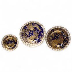 Set of three graduating Royal Crown Derby 'Aves Gold' pattern dinner plates, the gilt deco...