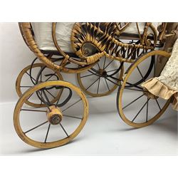 Two decorative wicker dolls prams, one with lace parasol,  and eleven dolls, including Leonardo Collection porcelain dolls, tallest pram including parasol H105cm