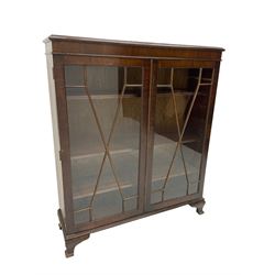 Early 20th century mahogany glazed display cabinet, enclosed by two astragal glazed doors, on ogee bracket feet