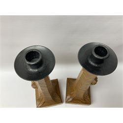 Mouseman - pair of tooled oak candlesticks, wrought iron sconce with drip tray over tapered octagonal column carved with mouse signature, terminating to stylised leaf carved square base, by the workshop of Robert Thompson, Kilburn
